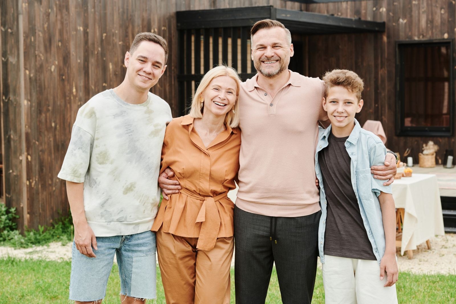 A family standing together in their backyard